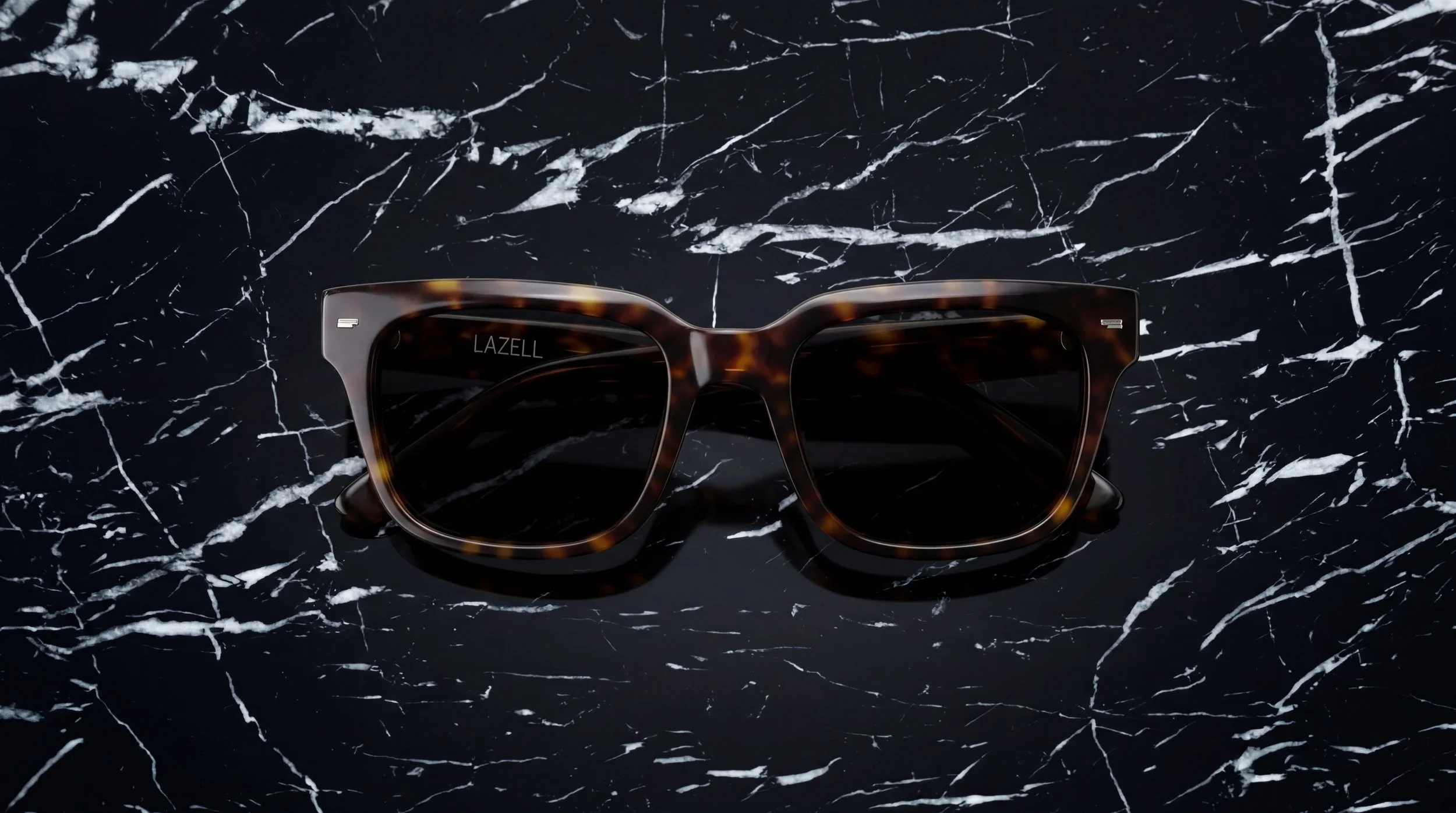 Tortoiseshell Lazell sunglasses on black marble